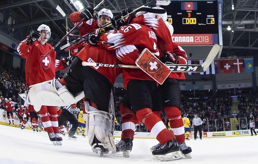 Switzerland players celebrate after their win over Sweden in a quarterfinal of the IIHF world junior hockey championships in Victoria, British Columbia, Wednesday, Jan. 2, 2019. (Joel Marklund/Pool Ph ...