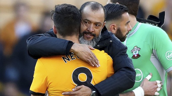 Wolverhampton Wanderers manager Nuno Espirito Santo hugs team member Ruben Neves after the final whistle of the game against Southampton during their English Premier League soccer match at Molineux st ...