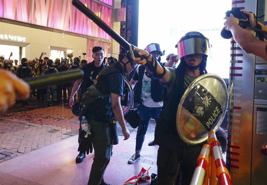 Riot police chase members of the media away in Hong Kong, Sunday, Sept. 8, 2019. Thousands of demonstrators in Hong Kong urge President Donald Trump to â??liberateâ? the semi-autonomous Chinese terri ...
