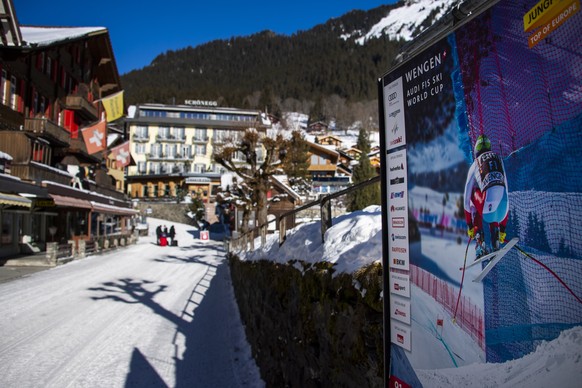 epa08931741 An advertising poster for the ski races is pictured in the street of the mountain village during the Coronavirus disease (Covid-19), in Wengen, Switzerland, Monday, January 11, 2021. The F ...