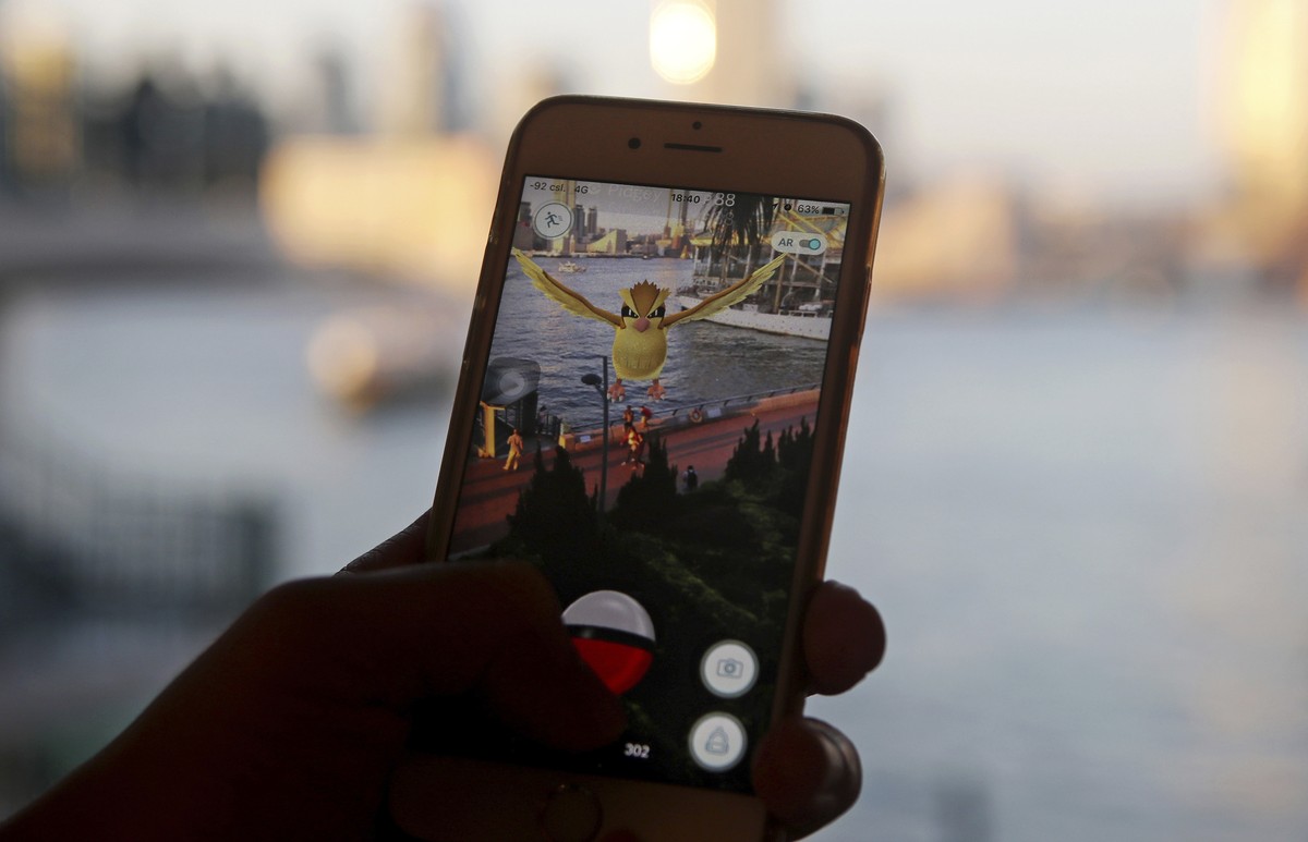 FILE - In this July 25, 2016, file photo, a fan maneuvers his smartphone as he plays "Pokemon Go" in Hong Kong. "Pokemon Go" is among Google's most-trending searches of 2016.  ...