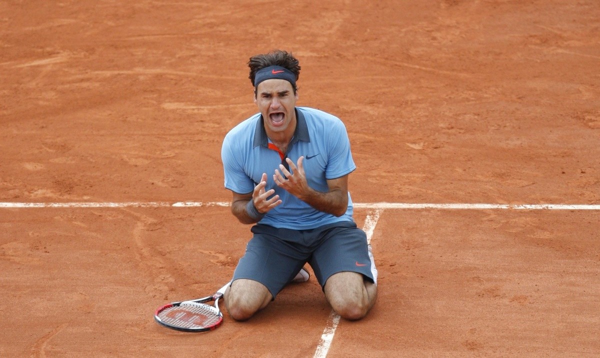 Switzerland's Roger Federer jubilates after defeating Sweden's Robin Soderling during their men's singles final match of the French Open tennis tournament at the Roland Garros stadium i ...