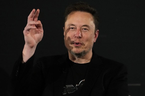 FILE - Elon Musk, owner of social media platform X, gestures during an event with Britain&#039;s Prime Minister Rishi Sunak in London on Nov. 2, 2023. The world could have its first trillionaire withi ...