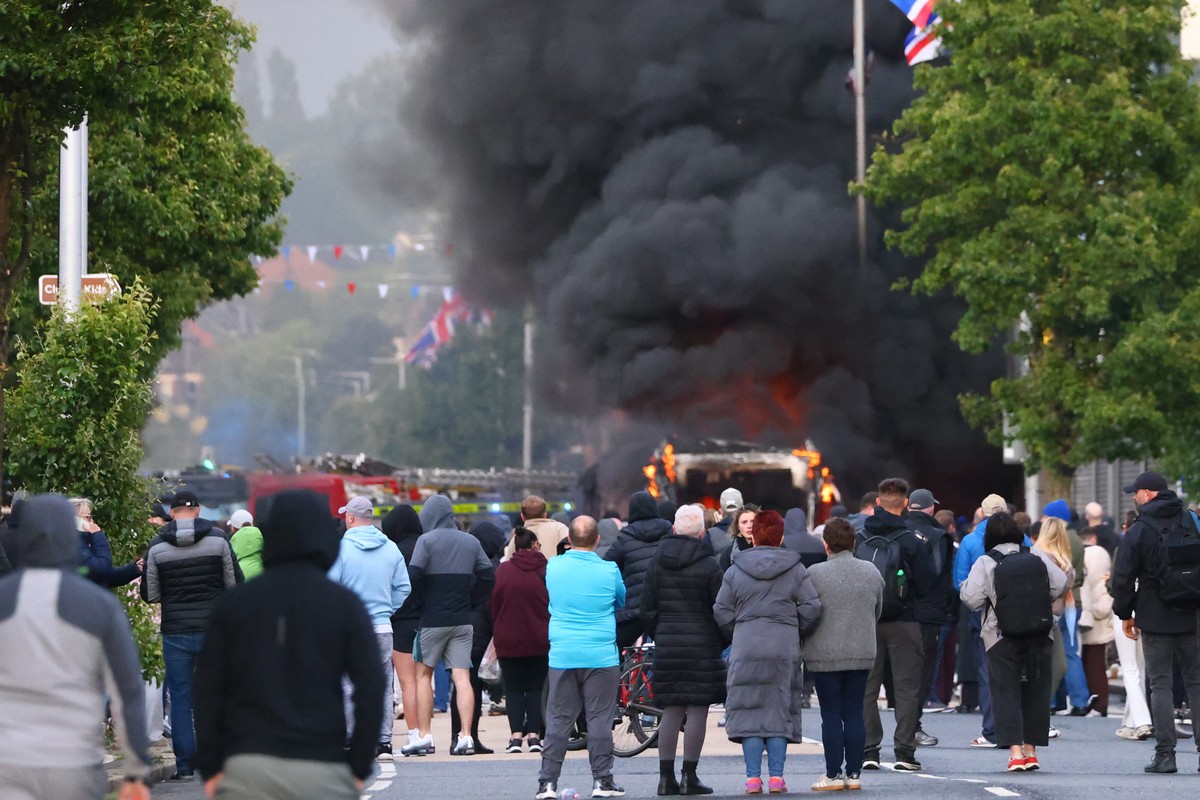 People watch as a vehicle burns during a protest following a stabbing incident in North Belfast, Tuesday, June 9, 2026. (AP Photo/Peter Morrison)
Britain Northern Ireland Stabbing