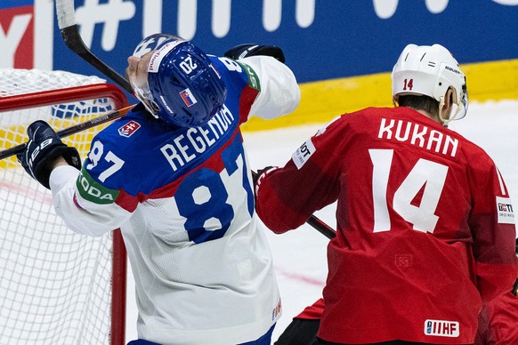 Switzerland&#039;s Dean Kukan, right, in action against Slovakia&#039;s Pavol Regenda during the Ice Hockey World Championship group A preliminary round match between Switzerland and Slovakia in Helsi ...