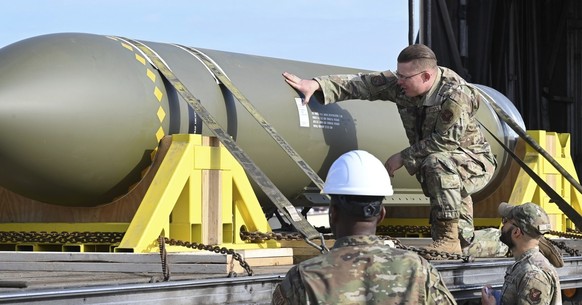 In this photo released by the U.S. Air Force on May 2, 2023, airmen look at a GBU-57, or the Massive Ordnance Penetrator bomb, at Whiteman Air Base in Missouri. That U.S. bomb, designed to destroy und ...