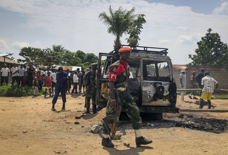 Congolese security forces attend the scene after the vehicle of a health ministry Ebola response team was attacked in Beni, northeastern Congo Monday, June 24, 2019. A driver working with the team is  ...