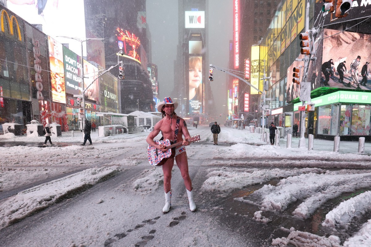The Naked Cowboy performs in Times Square during a winter storm in Manhattan, New York City on February 23, 2026. New York ordered drivers off the road and shut down schools on Monday, while residents ...
