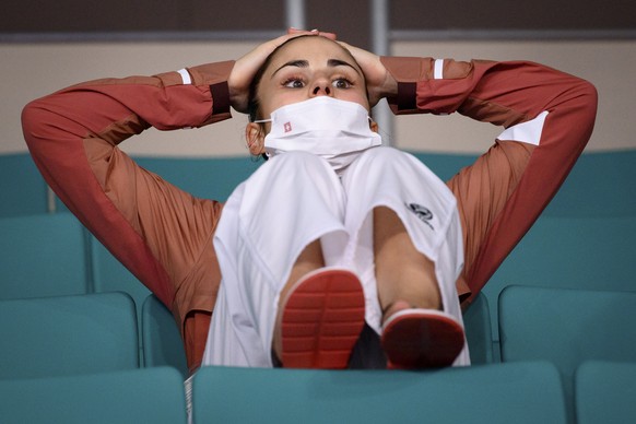 Elena Quirici of Switzerland reacts as she watches from the stand the fight that will decide if she continues in the semi-finals in the women&#039;s karate kumite +61kg fight at the 2020 Tokyo Summer  ...