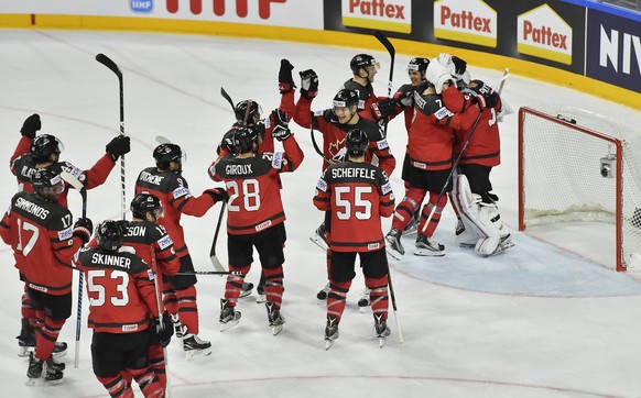 Canada&#039;s players celebrate their 4-2 victory at the Ice Hockey World Championships semifinal match between Canada and Russia in the LANXESS arena in Cologne, Germany, Saturday, May 20, 2017. (AP  ...