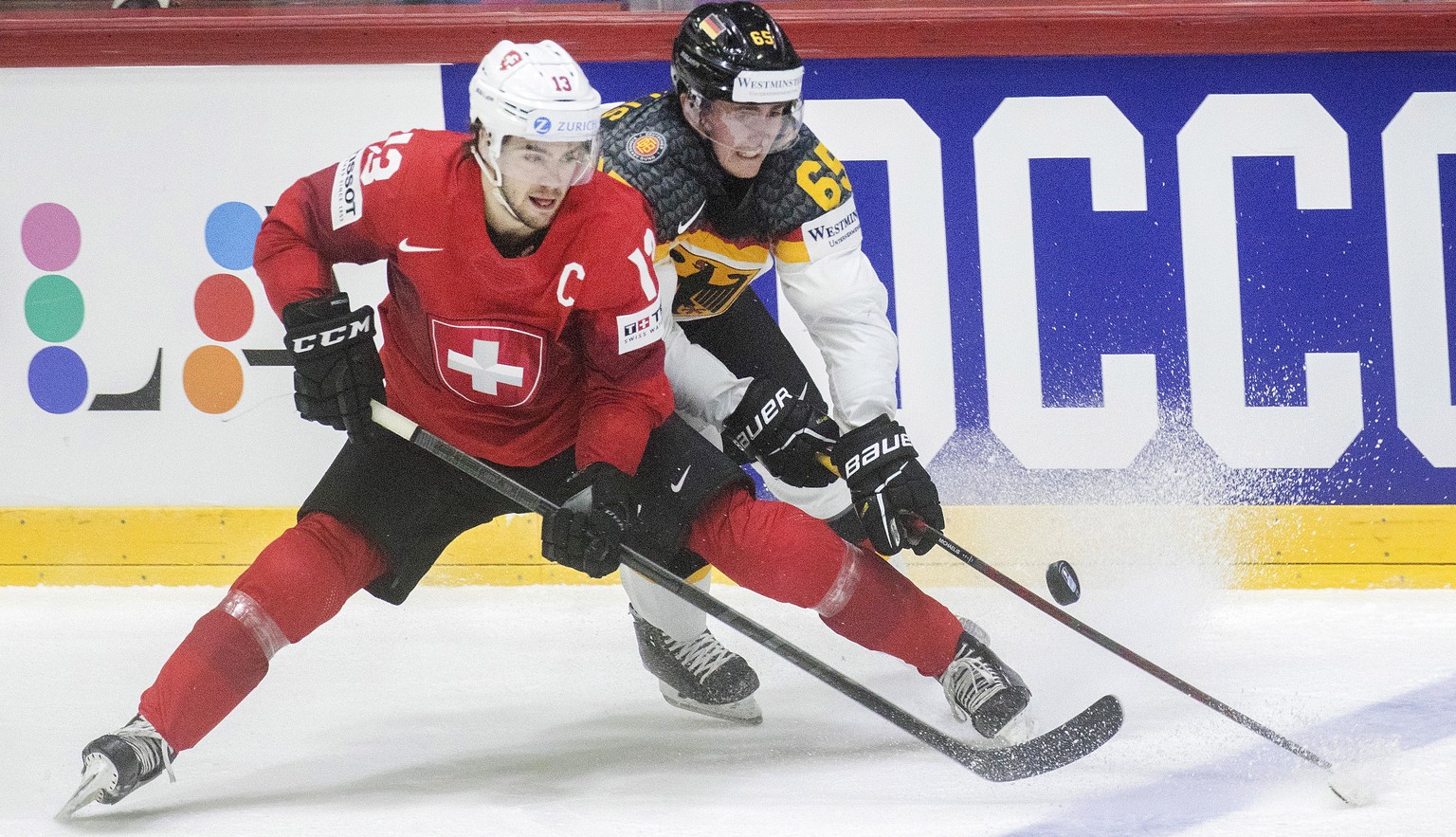 epa09971669 Nico Hischier (L) of Switzerland in action against Marc Michaelis (R) of Germany during the IIHF Ice Hockey World Championship group A preliminary round match between Switzerland and Germa ...