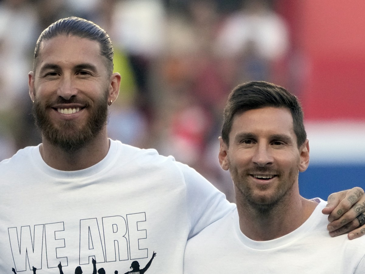 PSG's Lionel Messi, right, and PSG's Sergio Ramos smile during players presentation before the French League One soccer match between Paris Saint Germain and Strasbourg, at the Parc des Prin ...