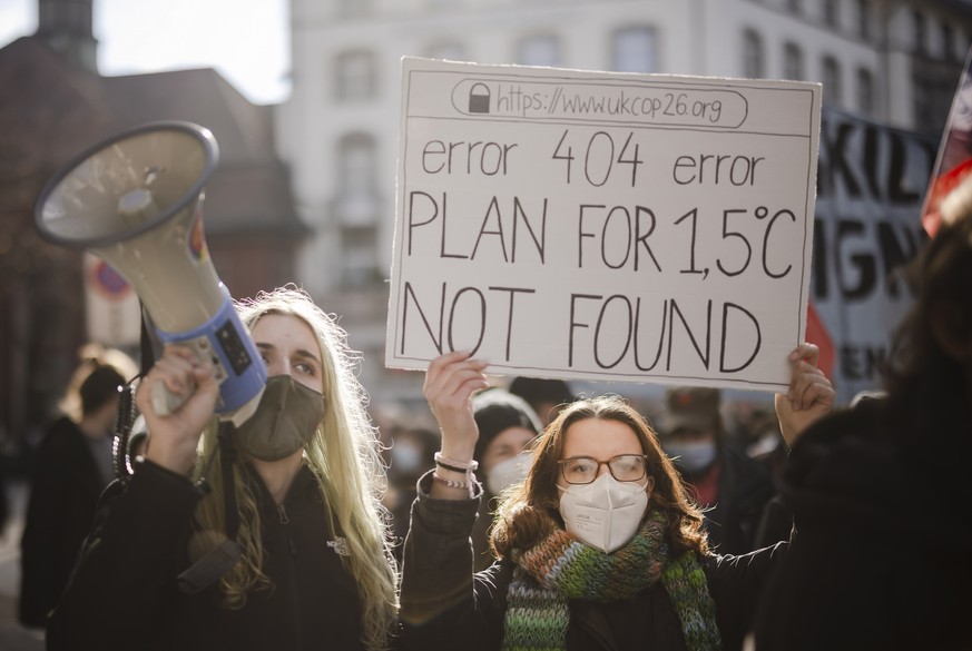 epa09567668 People attend a Climate Strike demonstration in Zuerich, Switzerland, 06 November 2021. People took part in the demonstration demanding world leaders to take action against climate change  ...