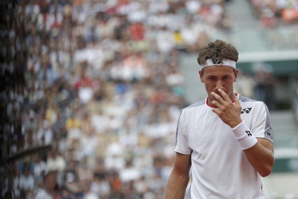 Norway's Casper Ruud walks back to the service line during his third round match of the French Open tennis tournament against Switzerland's Roger Federer at the Roland Garros stadium in Paris, Friday, ...