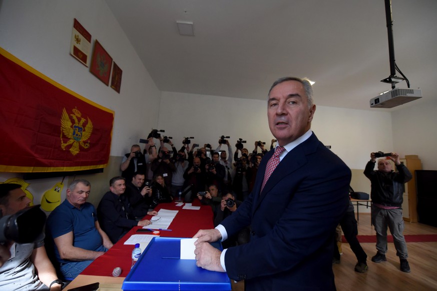 epa10531872 Presidential candidate and incumbent Montenegro&#039;s President Milo Djukanovic casts his ballot during the first round of the Presidential elections in Podgorica, Montenegro, 19 March 20 ...
