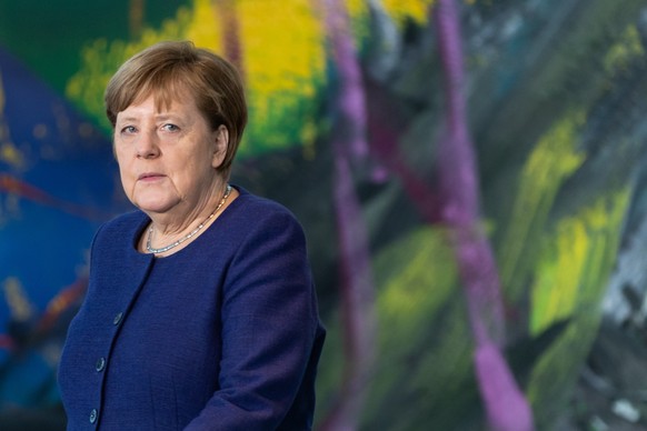 epa08292733 German Chancellor Angela Merkel arrives for a press statement prior to a conversation with the representatives of German business associations and the trade unions at the chancellery in Be ...