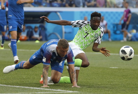 epa06831184 Ragnar Sigurdsson (L) of Iceland and Ahmed Musa of Nigeria in action during the FIFA World Cup 2018 group D preliminary round soccer match between Nigeria and Iceland in Volgograd, Russia, ...