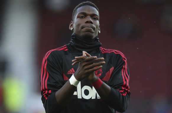 Manchester United's Paul Pogba applauds the fans as he takes part in the warm up prior to the start of the English Premier League soccer match between Manchester United and Leicester City at Old Traff ...