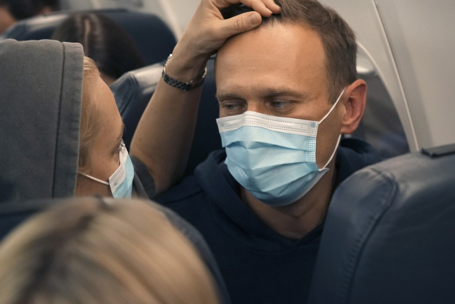 Alexei Navalny and his wife Yulia sit on the plane on a flight to Moscow, at the Airport Berlin Brandenburg (BER) in Schoenefeld, near Berlin, Germany, Sunday, Jan. 17, 2021. Leading Kremlin critic Al ...