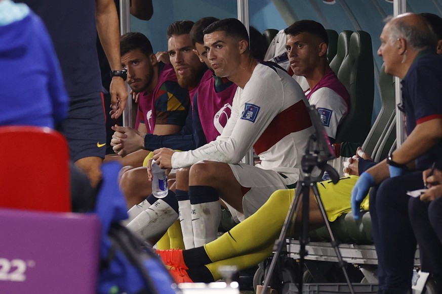 epa10344481 Cristiano Ronaldo of Portugal sits on the pitch after being substituted during the FIFA World Cup 2022 group H soccer match between South Korea and Portugal at Education City Stadium in Do ...