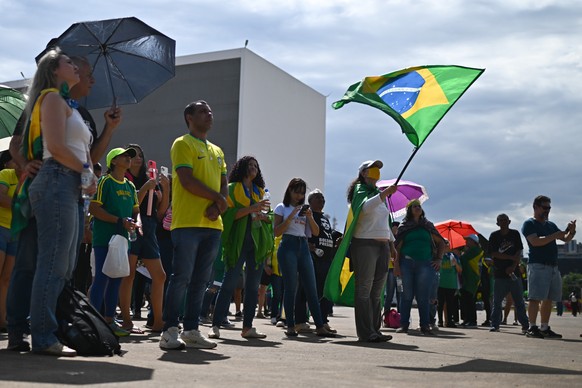 epa12560947 Supporters of former Brazilian President Jair Bolsonaro attend a protest against his imprisonment at the Esplanade of the Ministries government complex in Brasilia, Brazil, 30 November 202 ...