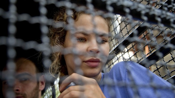 Anastasia Vashukevich sits in a police transport vehicle outside a detention center in Pattaya, south of Bangkok, Thailand, Wednesday, Feb. 28, 2018, after being arrested Sunday in the Thai resort cit ...