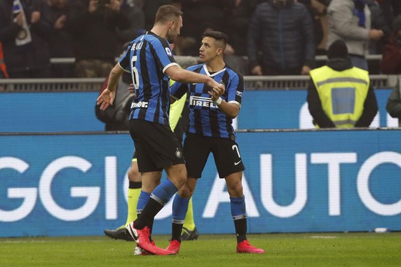 Inter Milan&#039;s Stefan de Vrij, left, celebrates with Inter Milan&#039;s Alexis Sanchez after his scored his side&#039;s third goal during the Serie A soccer match between Inter Milan and AC Milan  ...