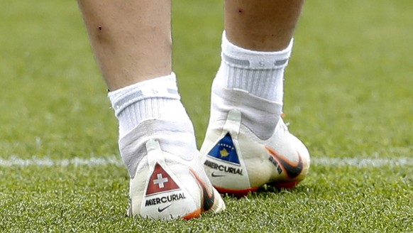 Switzerland&#039;s Xherdan Shaqiri wears soccer shoes with the national flags of Switzerland and Kosovo at the official training session of the Swiss team one the eve of the group E match between Swit ...