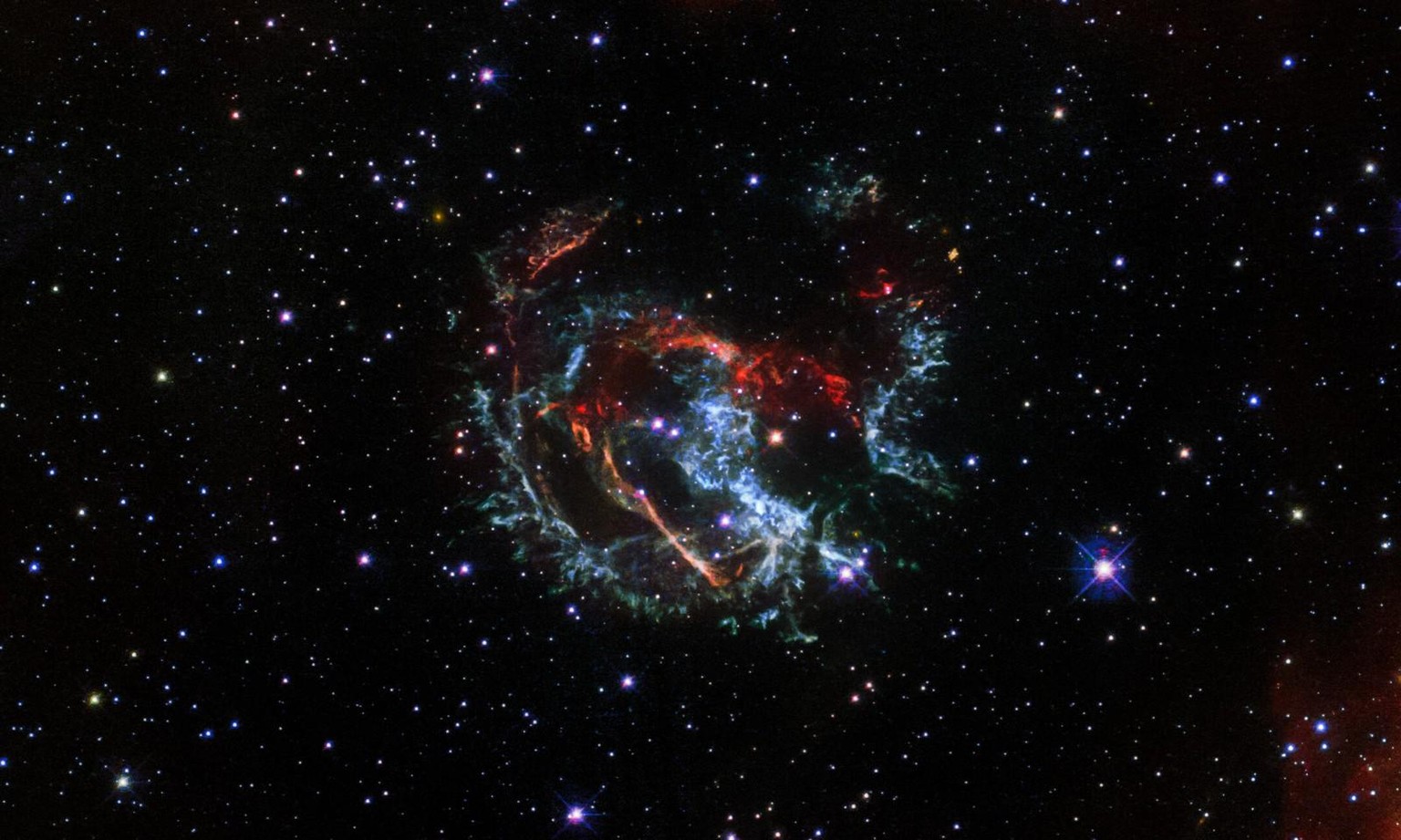 Featured in this Hubble image is an expanding, gaseous corpse — a supernova remnant — known as 1E 0102.2-7219. It is the remnant of a star that exploded long ago in the Small Magellanic Cloud, a satel ...