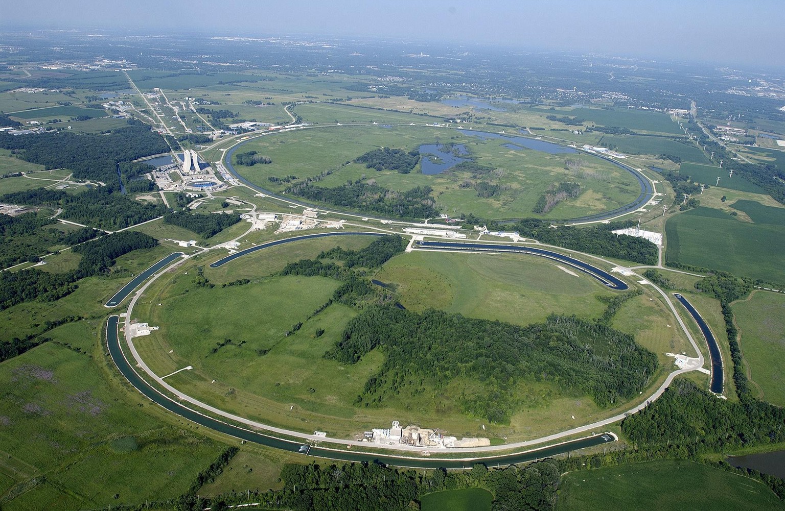 Das Tevatron (Hintergrund) und zwei Beschleunigungsringe.
https://de.wikipedia.org/wiki/Tevatron#/media/Datei:Fermilab.jpg