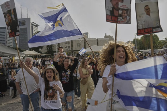 KEYPIX - People react as they gather to watch a live broadcast of Israeli-American soldier Edan Alexander to be released from Hamas captivity in Gaza, at a plaza known as the hostages square in Tel Av ...