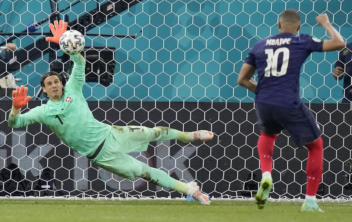 Switzerland's goalkeeper Yann Sommer saves the penalty shot by France's Kylian Mbappe during the Euro 2020 soccer championship round of 16 match between France and Switzerland at the Nationa ...
