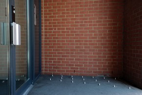 A picture shows short metal spikes installed outside the entrance of a building in London on June 10, 2014. The installation of pavement spikes to stop homeless people sleeping outside a London building sparked outrage on June 10, with 40,000 people signing a petition in protest and Mayor Boris Johnson calling them 