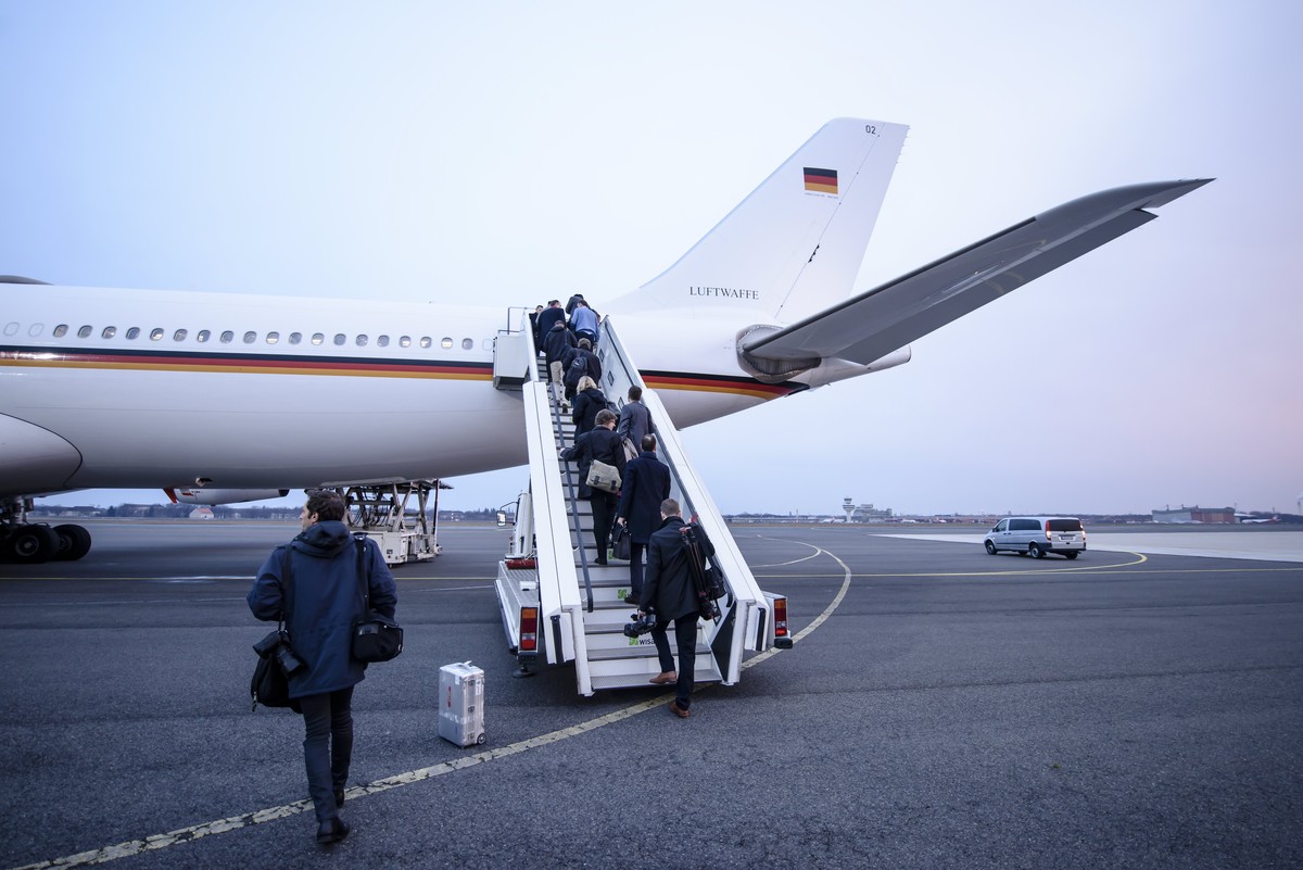 epa05846313 Journalists enter the German Air Force plane Airbus A340 'Theodor Heuss' at the military part of Tegel Airport prior to the take-off of German Chancellor Angela Merkel (not in th ...
