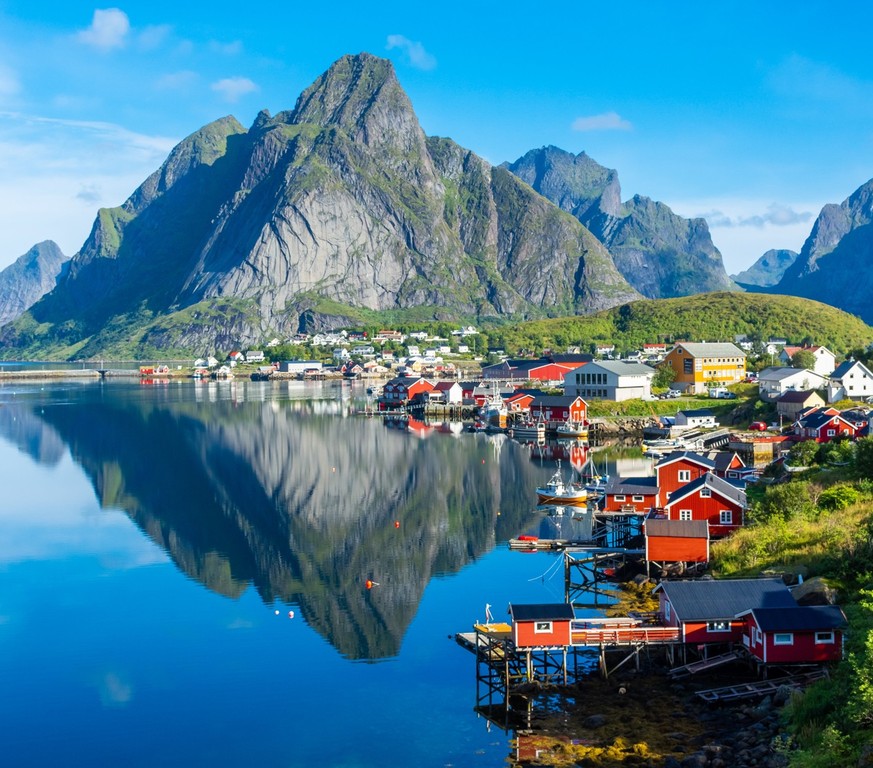 Perfect reflection of the Reine village on the water of the fjord in the Lofoten Islands, Norway