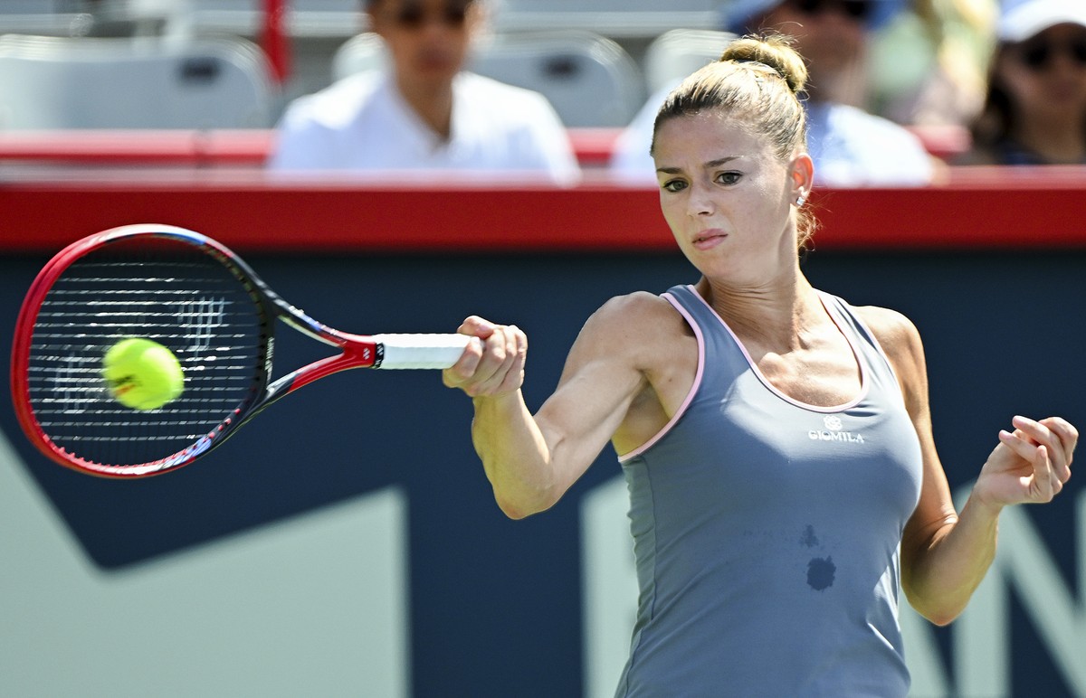 Camila Giorgi, of Italy, plays a shot to Elvina Kalieva, from the United States, during their qualifying match at the National Bank Open women's tennis tournament in Montreal, Saturday, Aug. 5, 2 ...