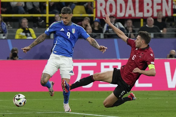 Italy&#039;s Gianluca Scamacca is challenged by Albania&#039;s Berat Djimsiti during the Group B match between Italy and Albania at the Euro 2024 soccer tournament in Dortmund, Germany, Saturday, June ...