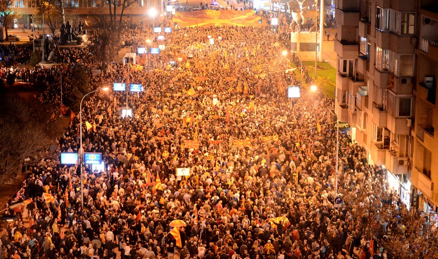 epa05862264 Thousands of supporters of the Civil Initiative for United Macedonia gather for a protest while European Commissioner for enlargement and Negotiations Johannes Hahn (not pictured) is meeti ...