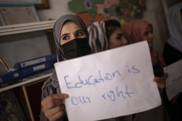 Women, teachers and students demonstrate inside a private school to demand for their rights and equal education for women and girls, during a gathering for National Teachers Day, in Kabul, Afghanistan ...