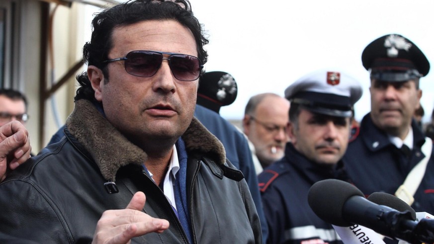 epa09680231 (FILE) - The captain of the &#039;Costa Concordia&#039;, Francesco Schettino (L) speaks to journalists in Giglio harbor after returning from the shipwrecked cruise liner of the Costa Crici ...