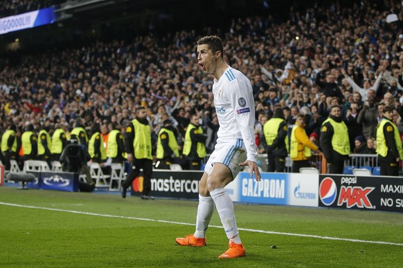 Real Madrid&#039;s Cristiano Ronaldo celebrates his side&#039;s 2nd goal during the Champions League soccer match, round of 16, 1st leg between Real Madrid and Paris Saint Germain at the Santiago Bern ...