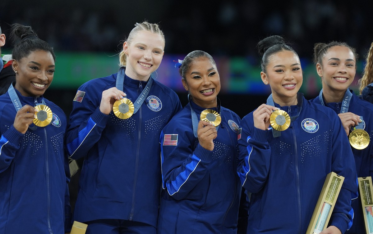 From left to right, Simone Biles, Jade Carey, Jordan Chiles, Suni Lee and Hezly Rivera celebrates after winning the gold medal during the women's artistic gymnastics team finals round at Bercy Ar ...