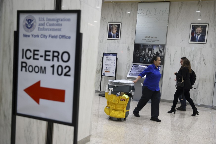 epa12468079 Portraits of US President Donald Trump and Vice President J.D. Vance hang in the lobby outside the US Immigration and Customs Enforcement (ICE) office at the Jacob K. Javits Federal Buildi ...