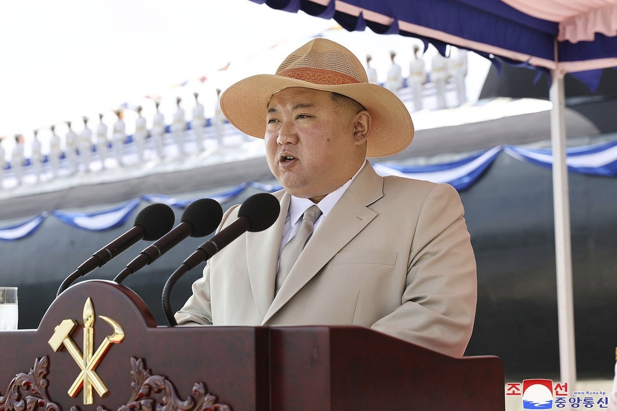 In this photo provided by the North Korean government, North Korea leader Kim Jong Un delivers a speech during a launching ceremony of what is says a new nuclear attack submarine "Hero Kim Kun Ok ...