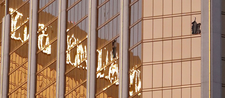 epa06240076 Broken windows seen on a high floor in the Mandalay Bay hotel facing the scene of the mass shooting at the Route 91 Harvest festival on Las Vegas Boulevard in Las Vegas, Nevada, USA, 02 Oc ...