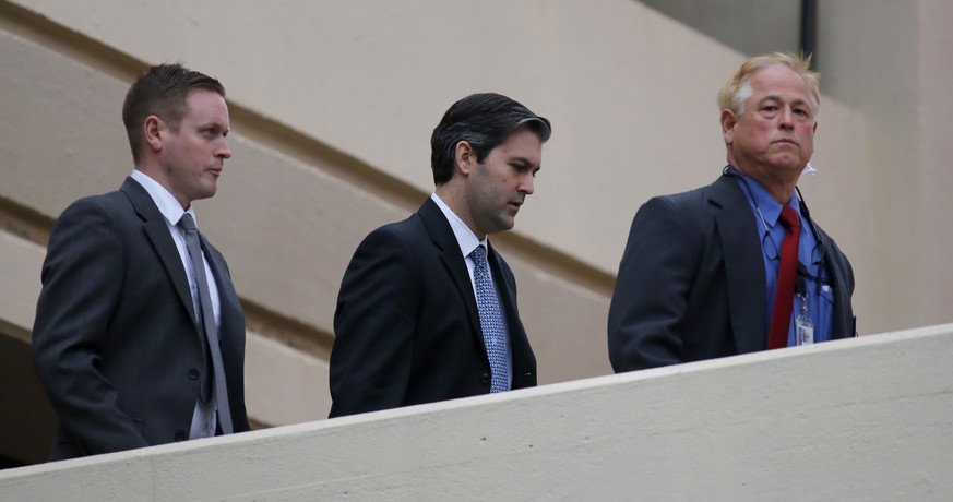 Michael Slager, center, walks from the Charleston County Courthouse under the protection from the Charleston County Sheriff&#039;s Department after a mistrial was declared for his trial Monday Dec. 5, ...