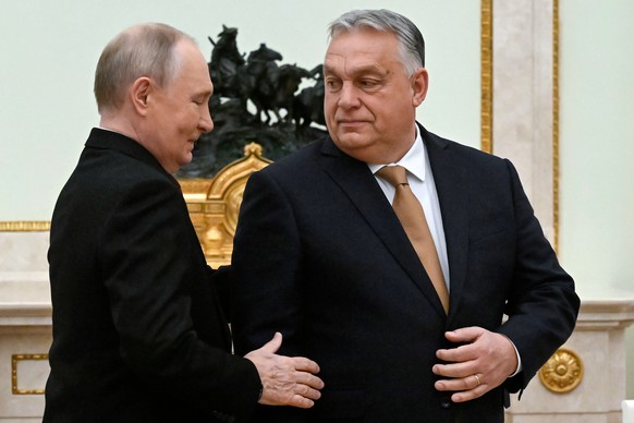 Russian President Vladimir Putin, left, speaks with Hungarian Prime Minister Viktor Orban during their meeting at the Senate Palace of the Kremlin in Moscow, Russia, Friday, Nov. 28, 2025. (Alexander  ...