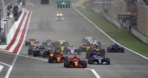 FILE- In this April 8, 2018 file photo, Ferrari driver Sebastian Vettel of Germany, center, leads at the start and followed by Mercedes driver Valtteri Bottas of Finland, right and Ferrari driver Kimi ...