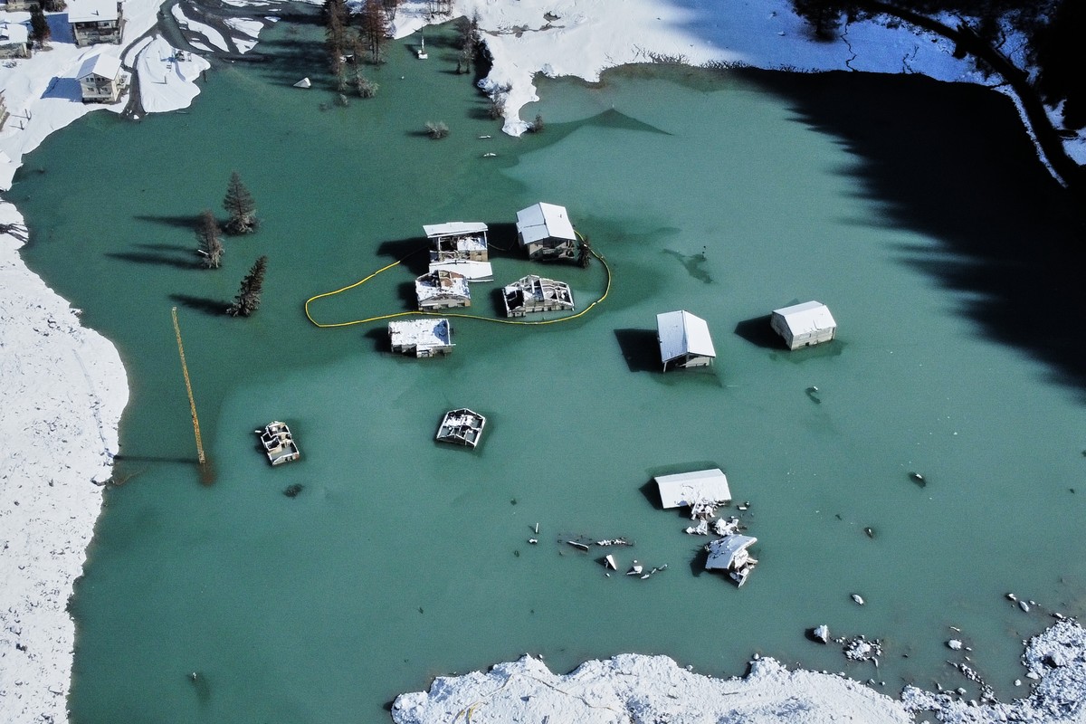 An aerial view shows the partly flooded village of Blatten after recent snowfalls, five months after a landslide destroyed the village, Blatten, Switzerland, on Tuesday, Oct. 28, 2025. (AP Photo/Micha ...