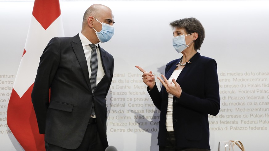 Bundespraesidentin Simonetta Sommaruga, rechts, und Bundesrat Alain Berset diskutieren am Ende einer Medienkonferenz des Bundesrates zur aktuellen Lage im Zusammenhang mit dem Coronavirus, am Dienstag ...